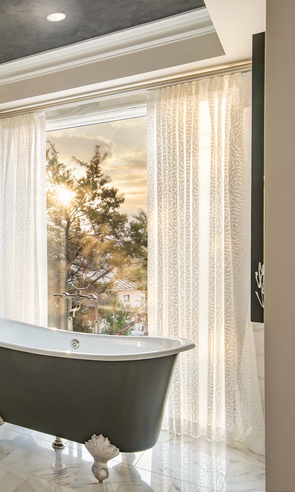 Close-up of Lutron Palladiom exposed roller shade brackets in brass.