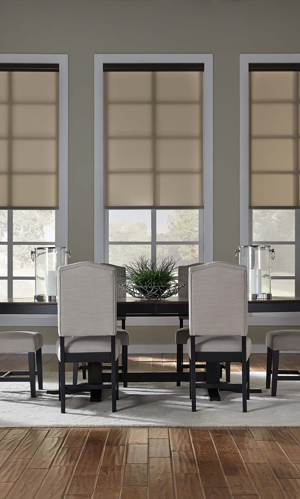 Dining room featuring three sheer Lutron Sivoia QS roller shades.