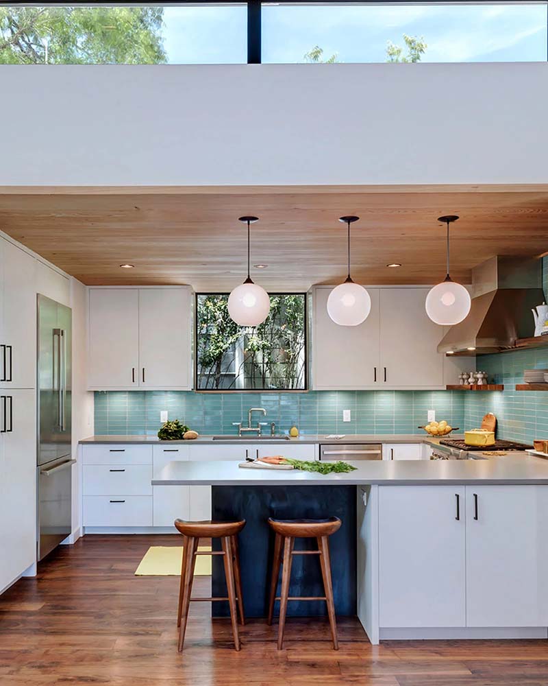 Modern Niche white glass pendants illuminated by Ketra in a kitchen.