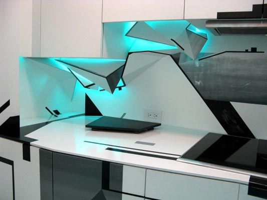 Modern kitchen countertop with unique geometric backsplashes glowing with integrated teal light